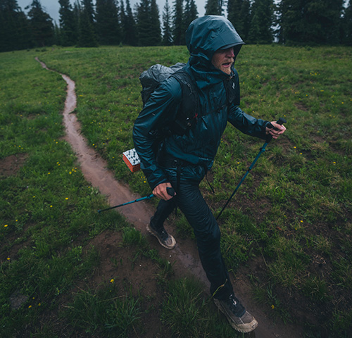 Joe Grant hiking in the rain using his Black Diamond walking poles